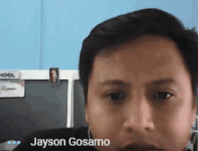 a close up of a man 's face with the name jayson gosamo at the bottom