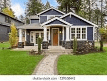 a large blue and white house with a lush green lawn in a residential neighborhood .