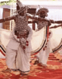 a group of people are dancing on a red carpet .