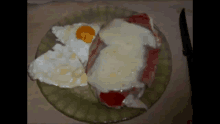 a close up of a plate of food with eggs and meat