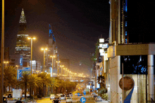 a busy city street at night with a pepsi sign in the middle