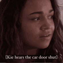 a close up of a woman 's face with the words " [kie hears the car door shut ] " below her