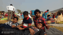 a group of young men are laying on the ground and one of them is wearing a shirt that says ' i love you '