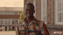 a man in a leopard print jacket is standing in front of a building with netflix written on the bottom