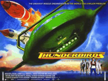 a movie poster for thunderbirds shows a group of people standing in front of a green spaceship .