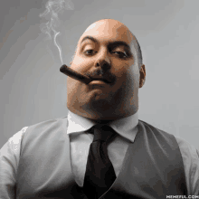 a man in a suit and tie smoking a cigar with memeful.com written on the bottom