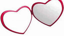 a pair of heart shaped mirrors with a red frame on a white background .