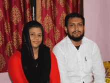 a man and a woman are posing for a picture