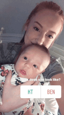 a woman is holding a baby with a question about who she looks like