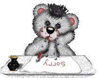 a teddy bear is sitting at a table writing sorry