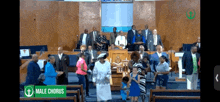 a group of people are gathered in a church with a green sign that says male chorus