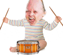 a baby playing drums with a pearl drum