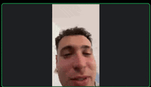 a man is talking on a video call with a green border around his face .