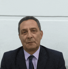 a man in a suit and tie with a white background