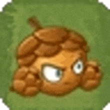 a cartoon acorn with a face is sitting on top of a green field .