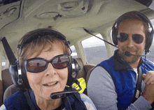 a man and a woman in a plane wearing headphones