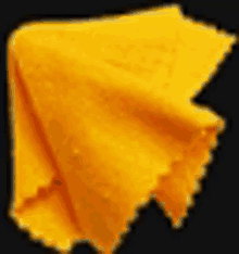 a close up of a yellow cloth on a black surface