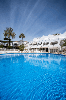 a large swimming pool in front of a hotel