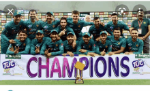 a group of cricket players pose for a photo with a banner that says champions