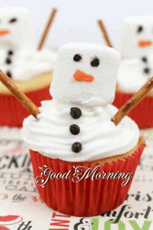 a cupcake decorated to look like a snowman with the words good morning written below it