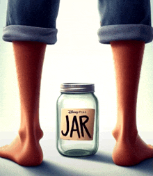 a person standing next to a jar with the word jar on it