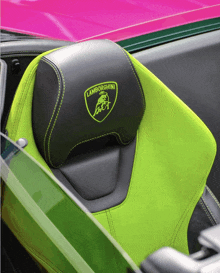 a green and black lamborghini seat with a green logo on it