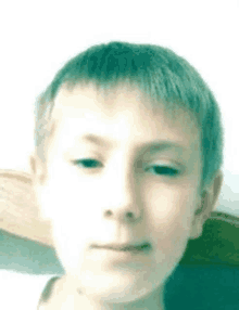 a close up of a young boy 's face with a white background .