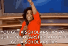 a woman in a red dress is holding a microphone and says you get a scholarship !