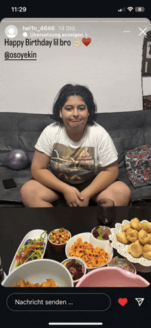 a girl is sitting on a couch in front of a table full of food and a message that says happy birthday lil bro