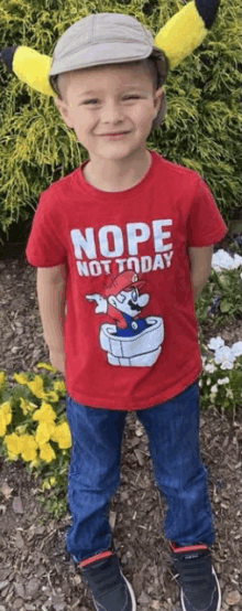 a young boy wearing a red t-shirt that says nope not today