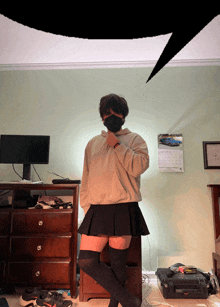 a person wearing a skirt and knee high socks stands in a room