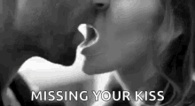 a man and a woman are kissing in a black and white photo with the words `` missing your kiss '' .