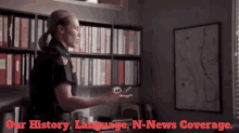 a woman in a police uniform stands in front of a bookshelf with the words " our history language n-news coverage "