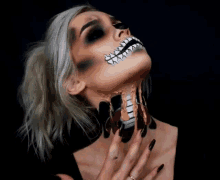 a woman with a skeleton makeup on her face