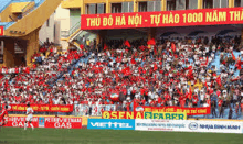 a large crowd of people are watching a soccer game in a stadium with a banner that says thu do ha noi