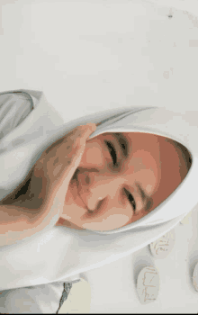 a girl wearing a white hijab is smiling