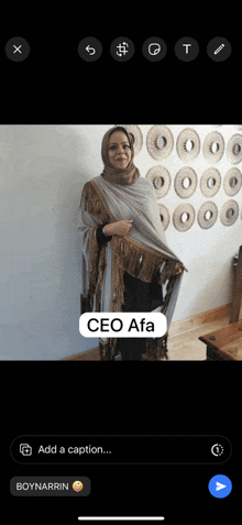 a woman in a hijab is standing in front of a wall with circles on it and the caption ceo afa