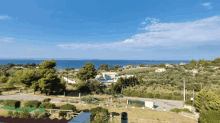 a view of the ocean from a rooftop with a chimney in the foreground