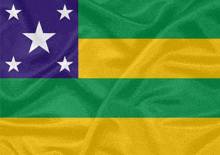 a green , yellow , and blue flag with white stars on it .