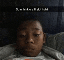 a young boy laying in bed with a caption that says so u think u a lil slut huh ?