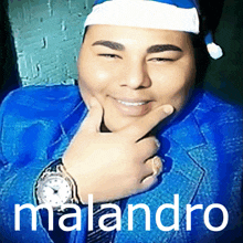 a man wearing a santa hat and a watch with the name malandro on the bottom