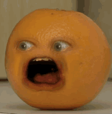 a close up of an orange with a cartoon face on it