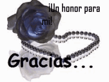 a black rose and a necklace with the words gracias in black letters