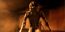 a monster with horns is standing in a dark room holding a sword .