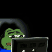 a cartoon frog is sitting in front of a computer screen .