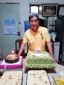 a man wearing a yellow polo shirt stands in front of a birthday cake with the number 87 on it