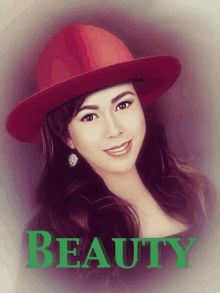 a woman wearing a red hat with the word beauty in green letters