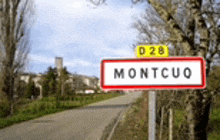 a red and white sign on the side of a road says montcuo