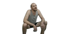 a man squatting down with a white background