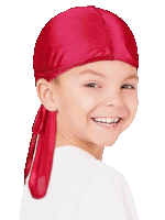 a young boy wearing a red bandana on his head is smiling .